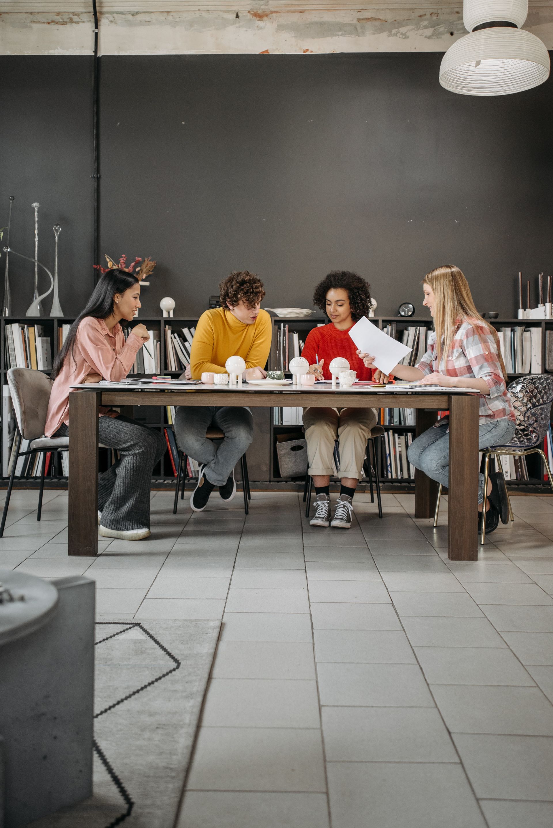 Students gathered around a study table during a lesson